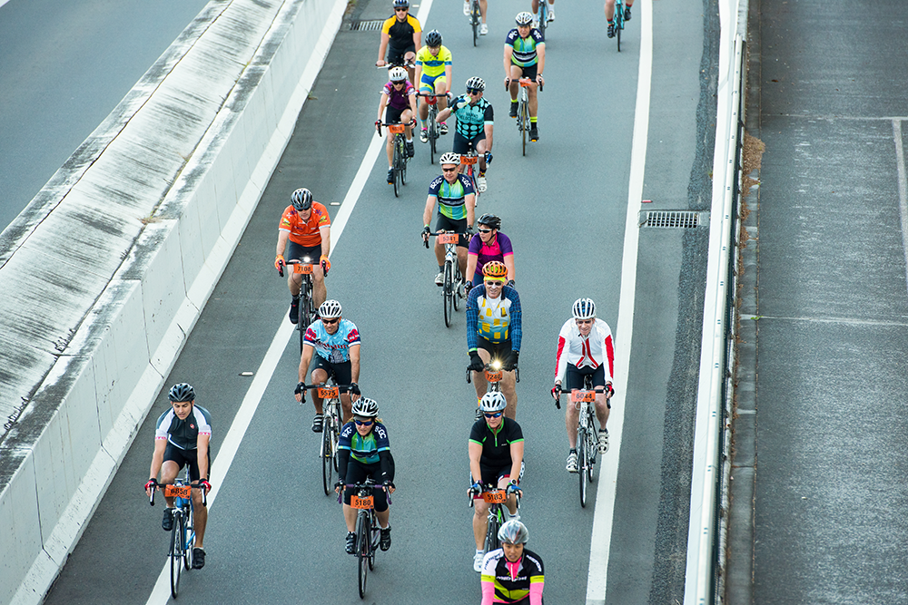 Downer sponsors Brisbane to Gold Coast Cycle Challenge Bike riders on bridge