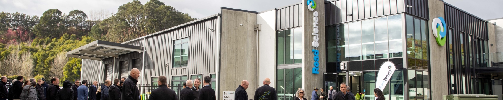 Road Science building exterior with opening event guests in foreground